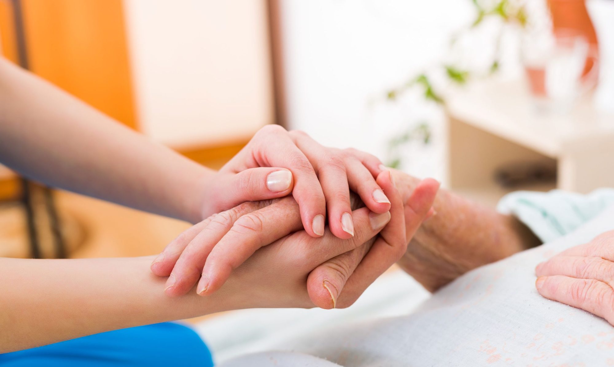 springfield-care-home-nurse-holding-hand-elderly-resident